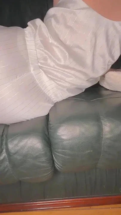 Farting in White Satin Pajama on Green Leather Sofa
