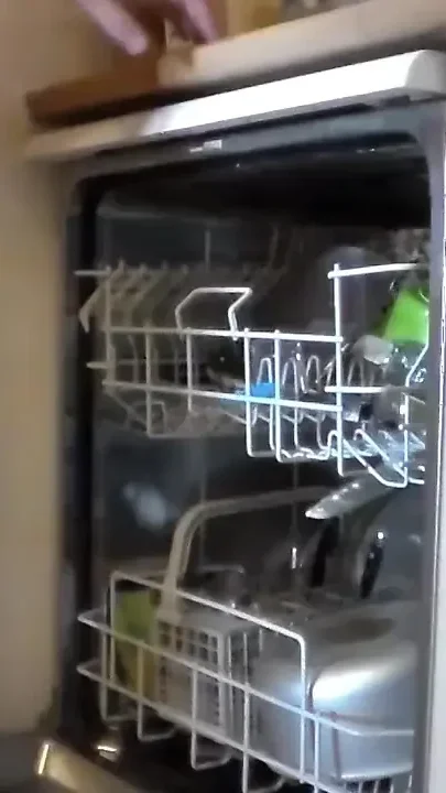 John is peeing into the dishwasher when it is full