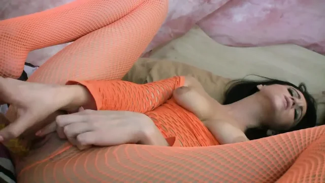 Babe in fishnet outfit rips pantyhose and puts a dildo in her shaved cunt