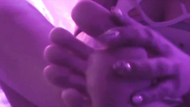 Young Girl Using Her Feet to Play with the Dildo While Masturbating