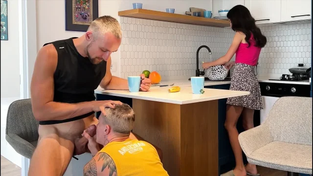 While the wife is cleaning the kitchen her husband is giving his best friend a