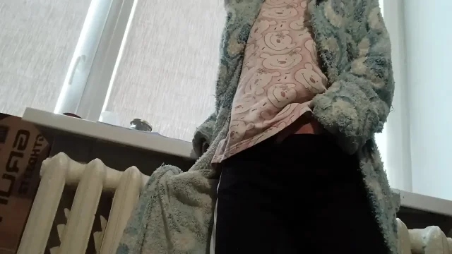 A slender brunette in a robe masturbates at home after university