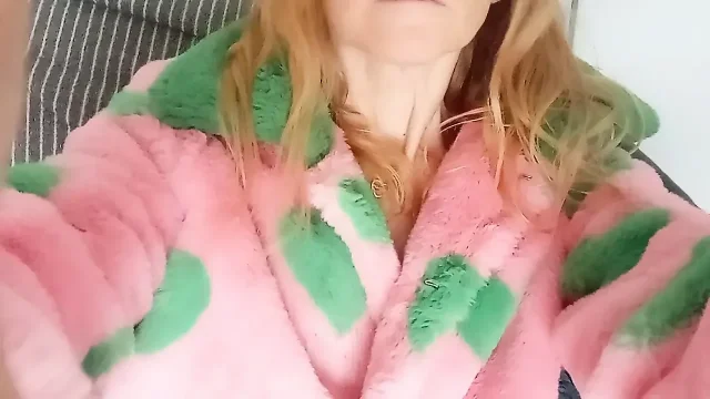 In pink fur coat with green hearts