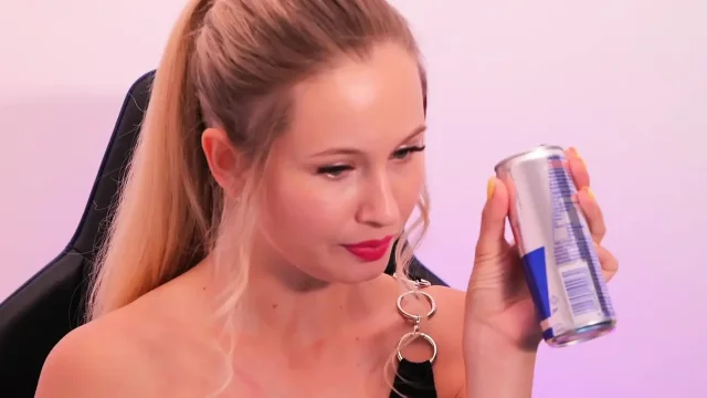 A beauty with red lipstick sucks her finger