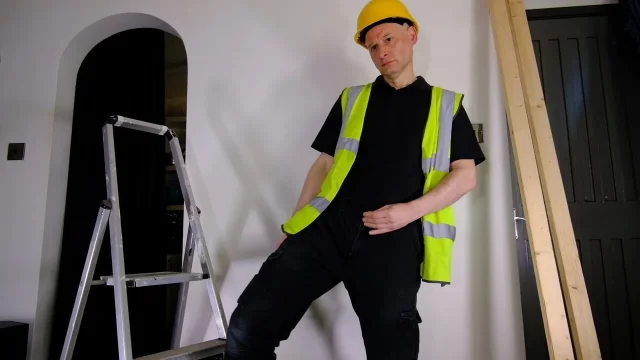 Workman strips naked and masturbates his uncut cock getting an erection wearing hard hat
