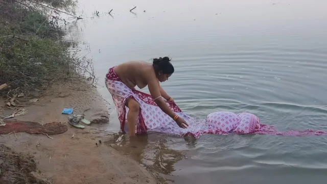 Indian village wife bathing in the river in outdoor area
