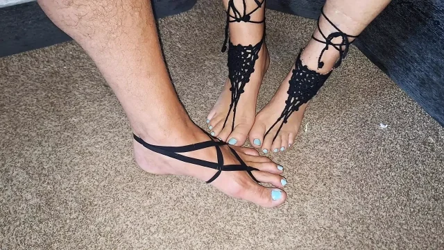 Playing footsie while wearing black strappy barefoot jewelry
