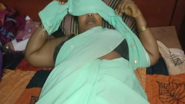 My neighbor's aunt was beautiful in a saree on the bed I gently rubbed her