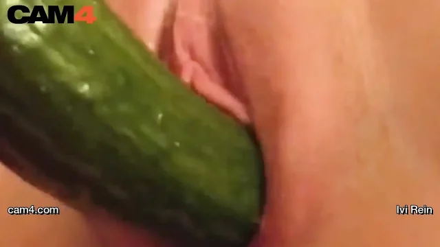 Webcam hottie Ivi Rein toys herself with a long cucumber