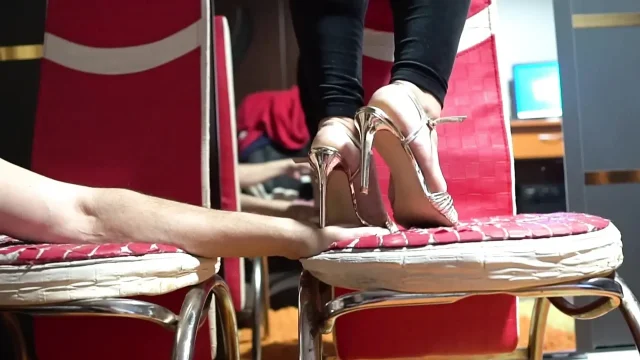 Tramples with heels on the hands