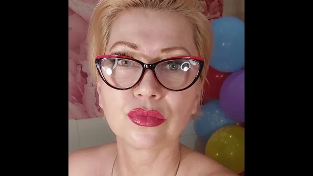 Dildoing of a mature bitch on a background of colorful balloons