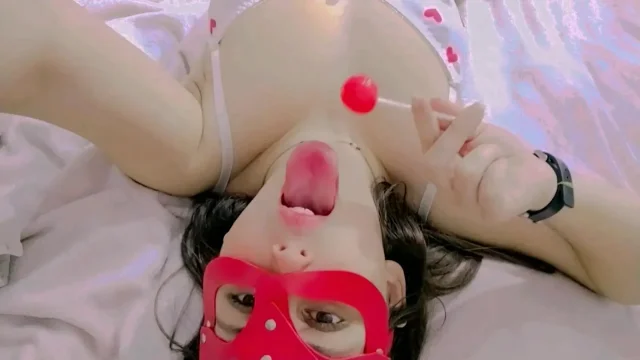 Hot and naughty student sucking lollipops at the bed wearing her new white