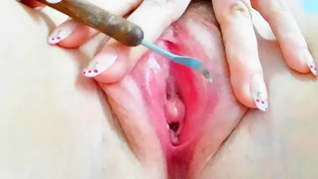 squeezing fluid from inside her pink pussy